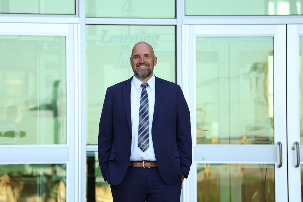 a principal smiling.