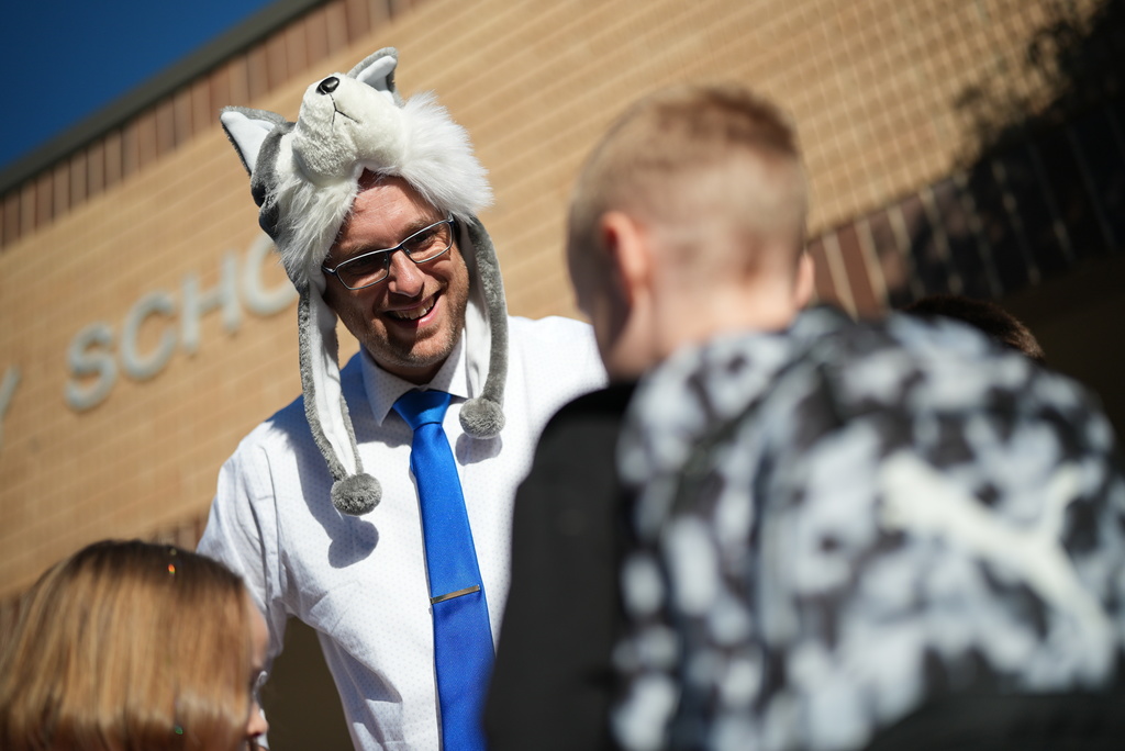 A principal smiles.
