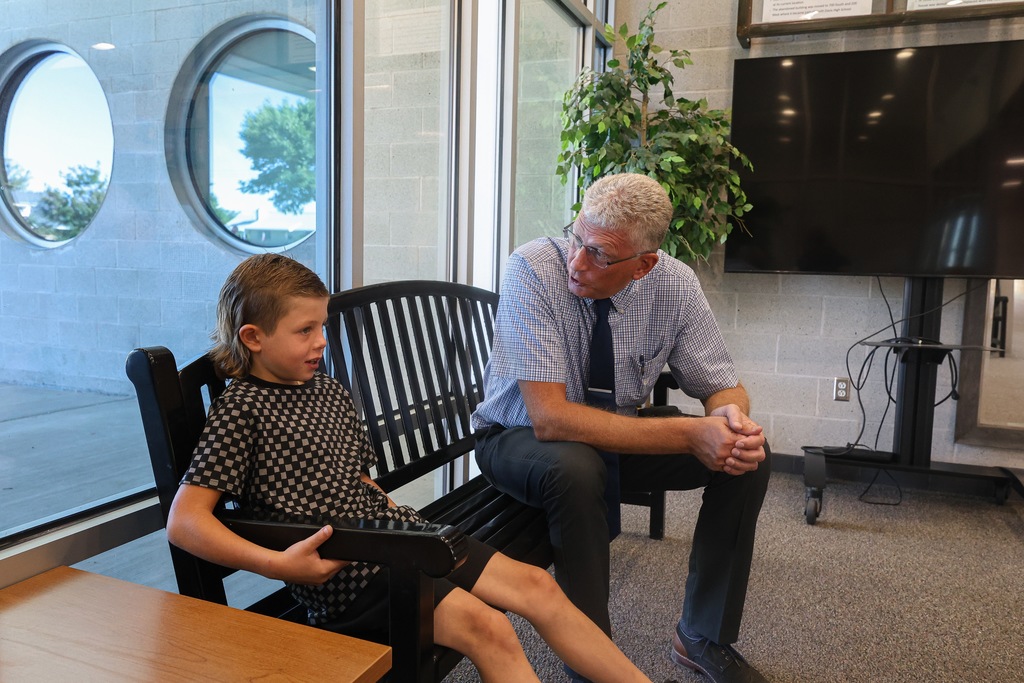 a student talking with a principal.