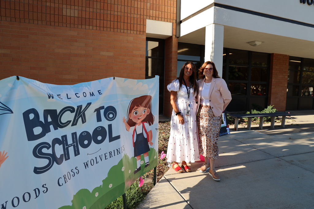 the admin stand in front of the school.