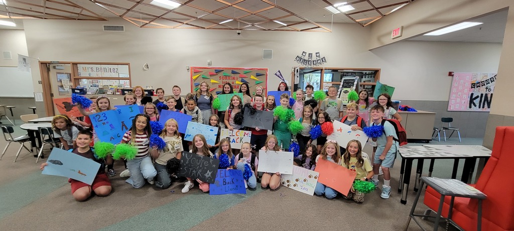 Students Leadership holding welcome back posters and pom-poms.