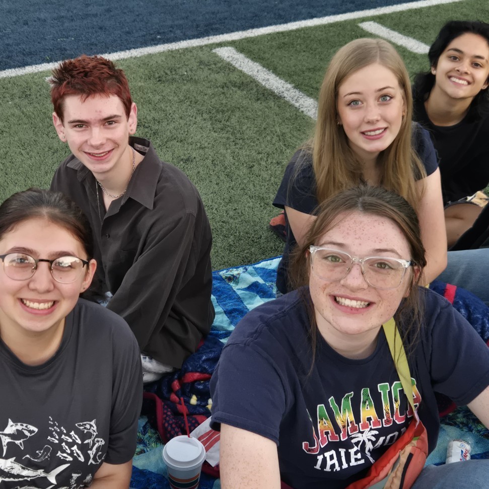 students sitting and smiling for pictures