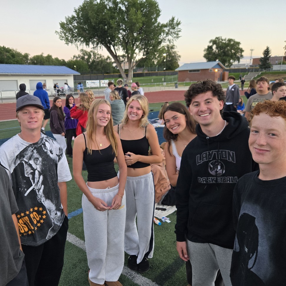 students standing and smiling for a picture