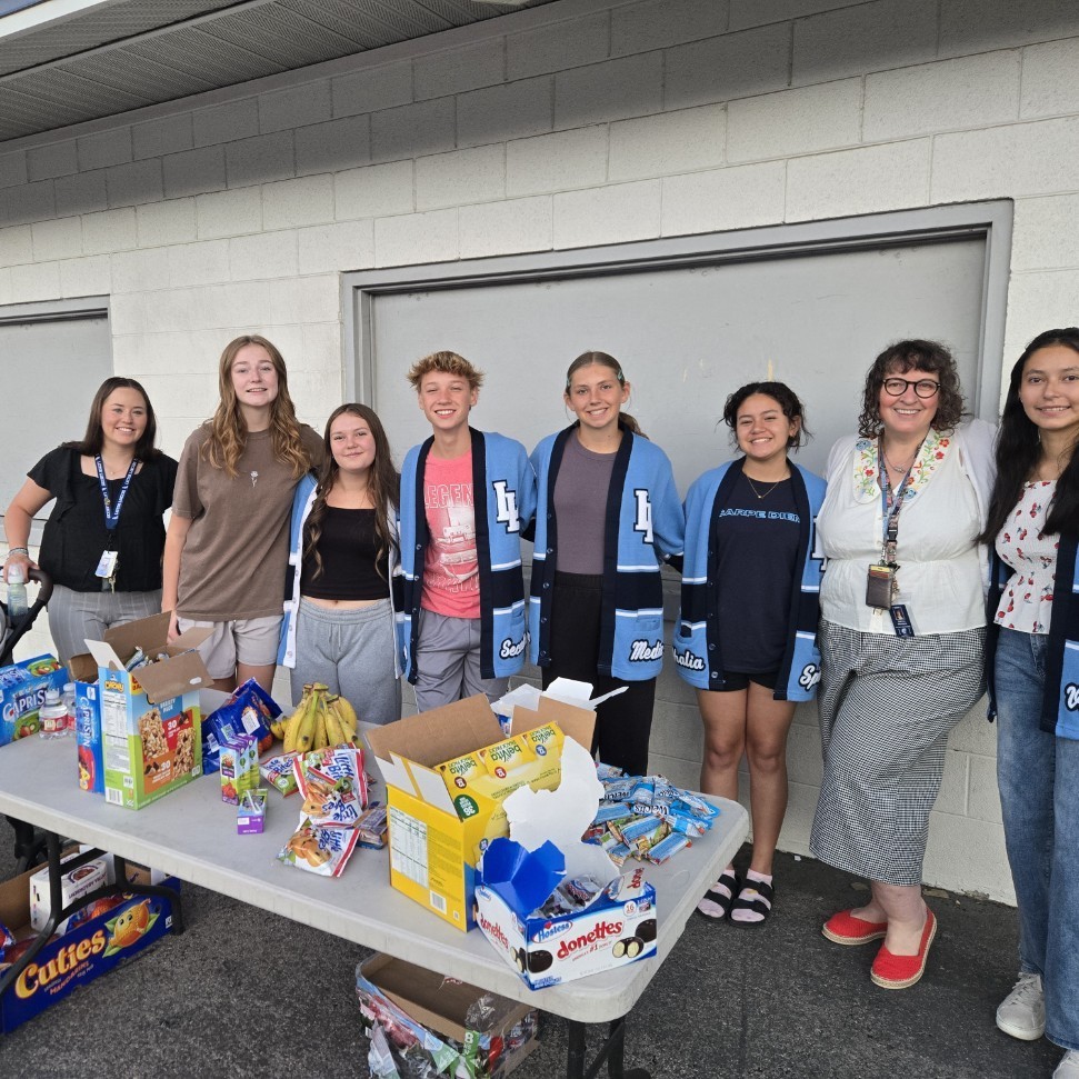 student government officers and advisors serving snacks