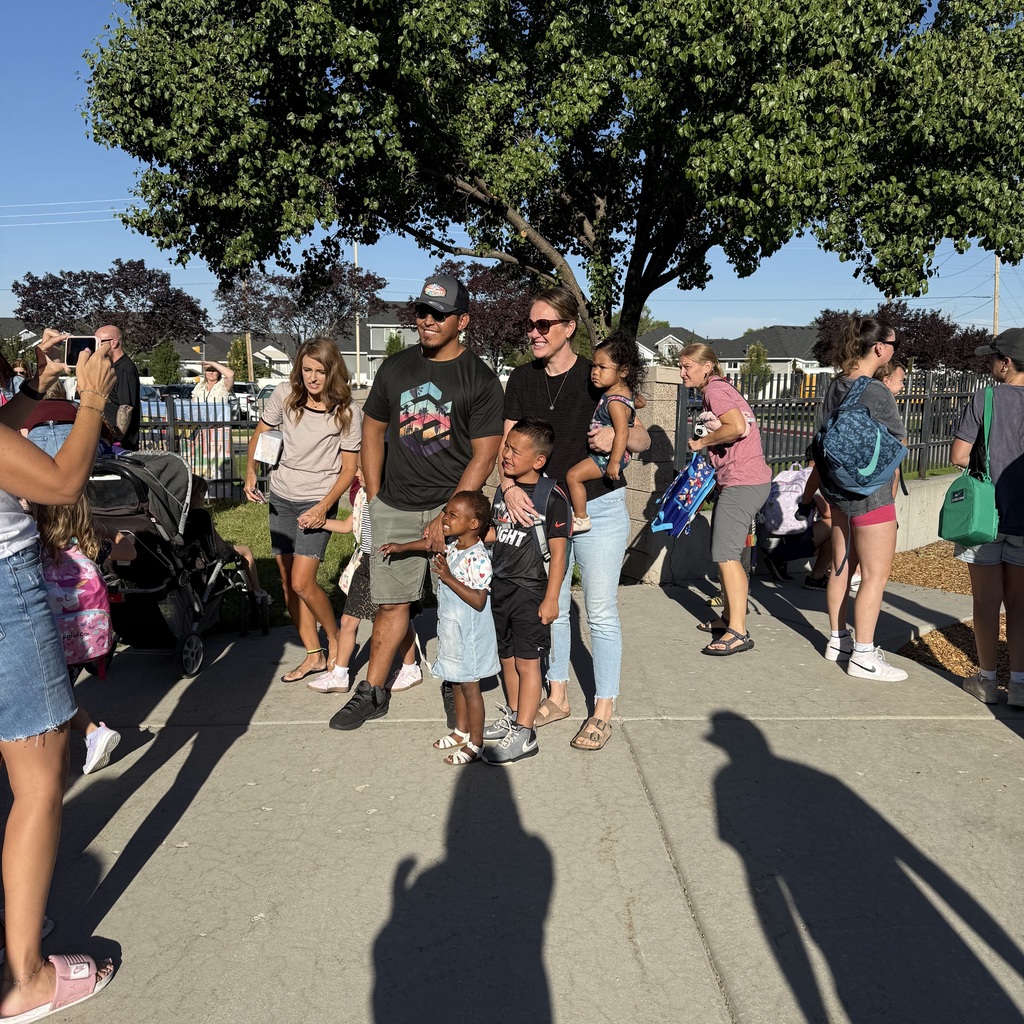 Family posing for a picture on the first day of Kindergarten. 
