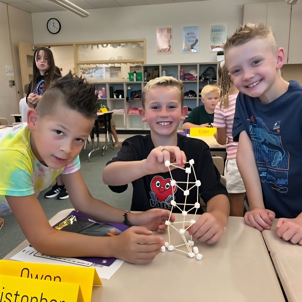 Students build a tower out of toothpicks and marshmallows. 