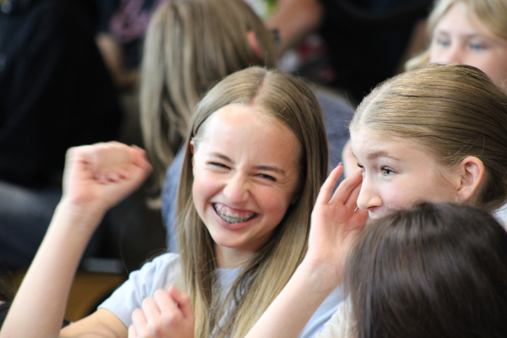 Two girls smiling and cheering.