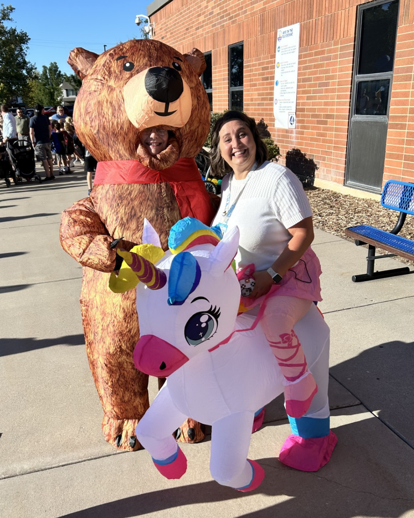Educators wearing a blow up bear and unicorn costume.