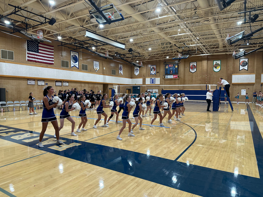 Fairfield's Cheer team is lined up in two rows as they are performing a cheer.