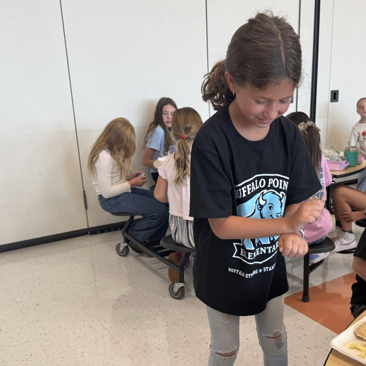 A girl dancing in the cafeteria