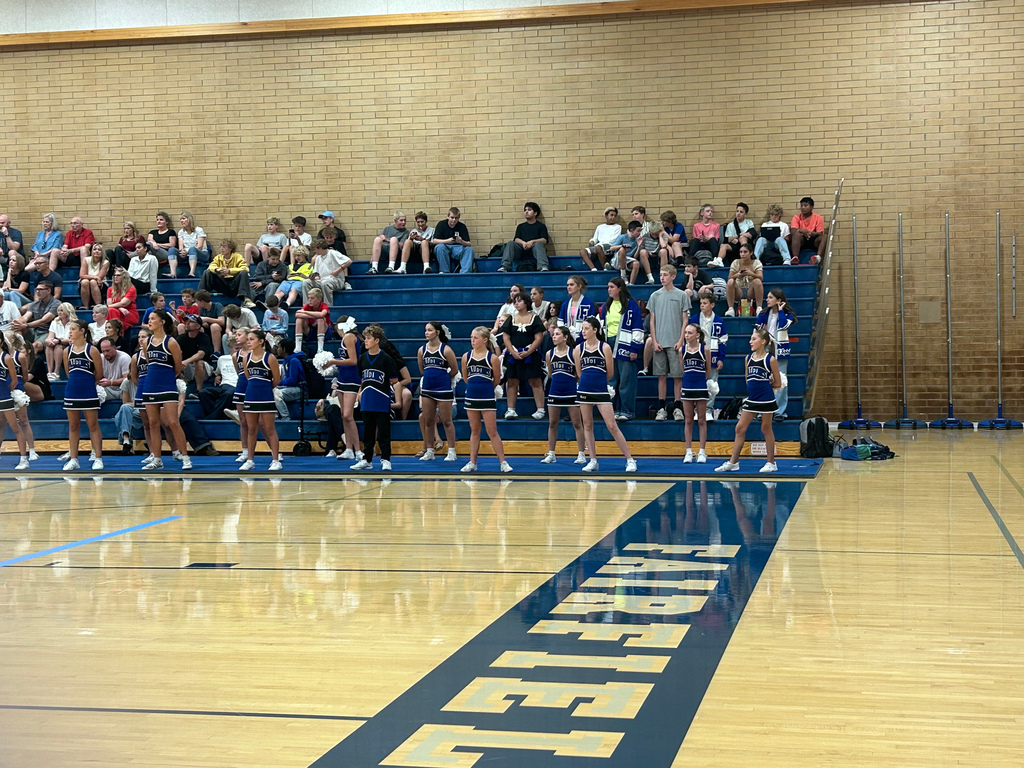Fairfield's cheer squad is standing ready with the crowd behind them in the bleachers.