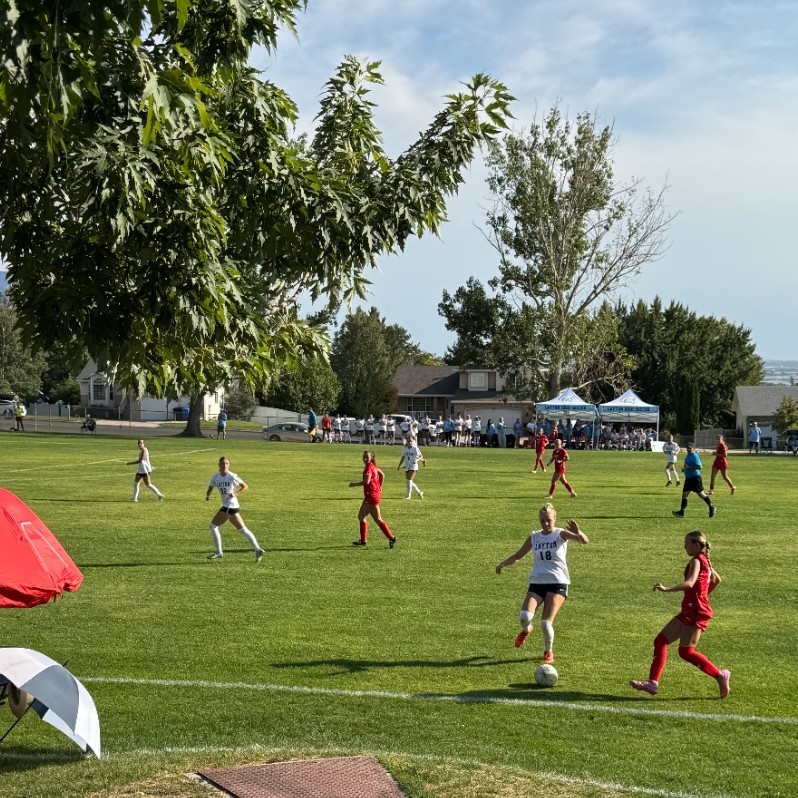 Layton soccer player dribbling by the sideline