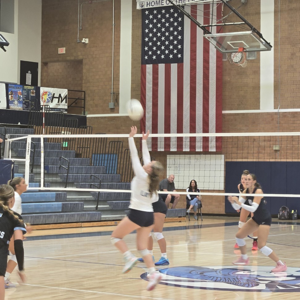 Lancers volleyball player sets the ball