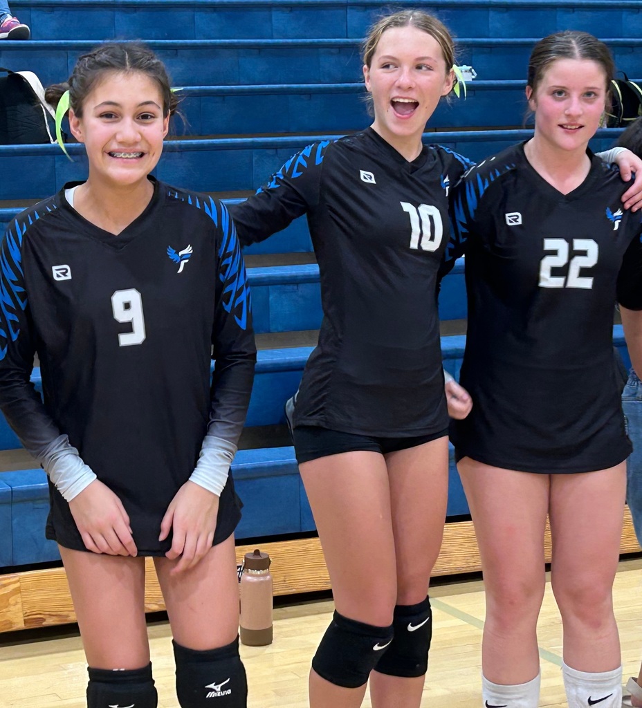 Three of Fairfield's players standing and smiling at the camera.