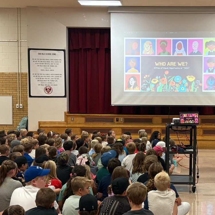 assembly with elementary students gathered in a gym