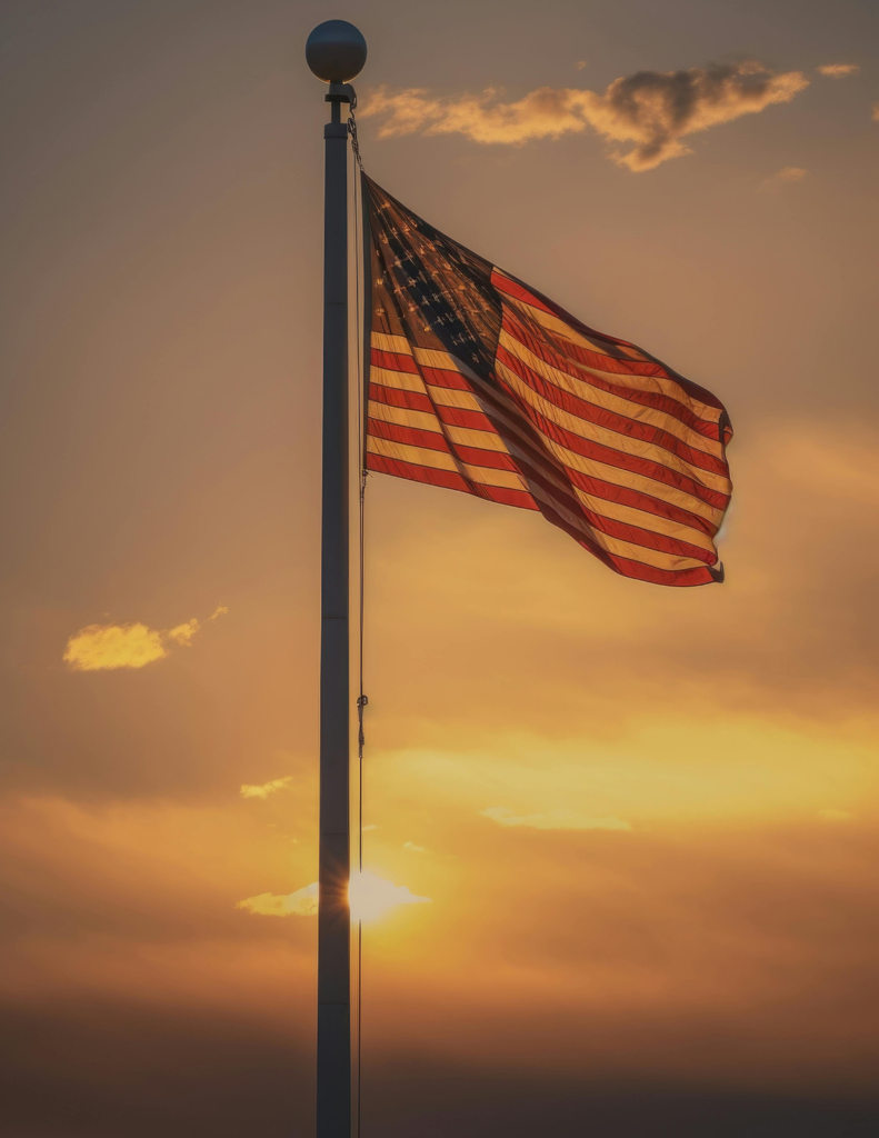 American flag with sunset in background