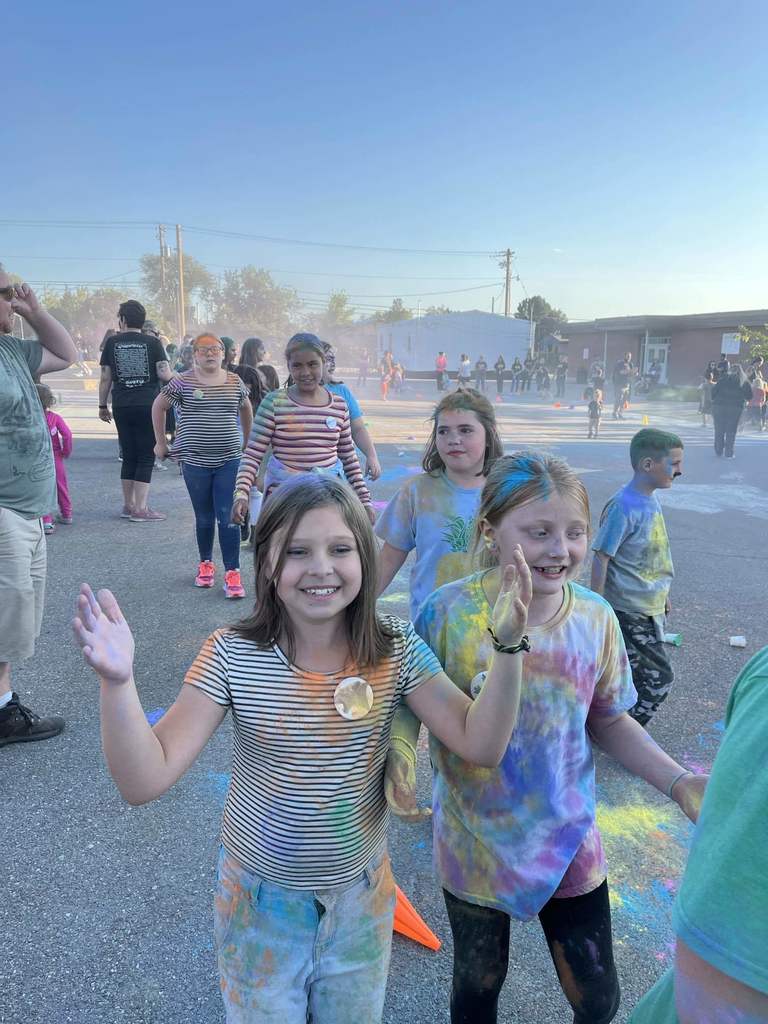 Last years students laughing and walking around the playground covered in chalk dust. 