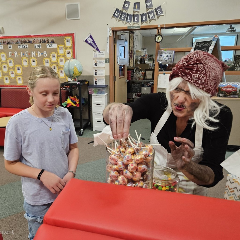 Mrs. Pratchett giving candy to a student.
