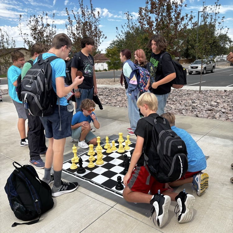 Students playing on a jumbo chess board