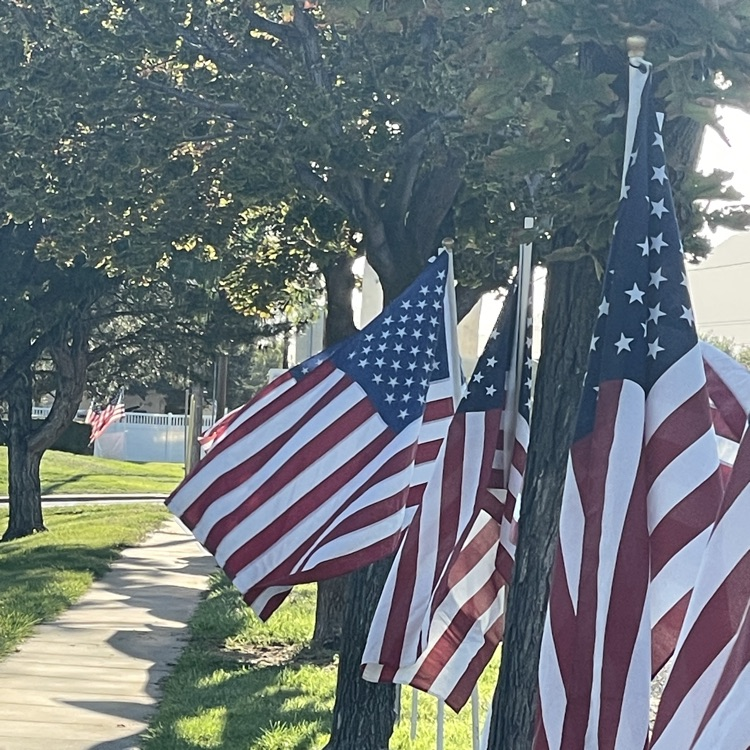 American Flags line the front of West Clinton Elementary on Patriot Day 2025