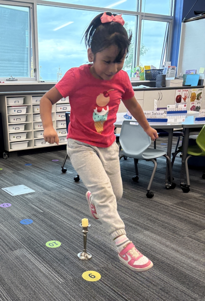 Girl in a pink shirt jumping over a candlestick