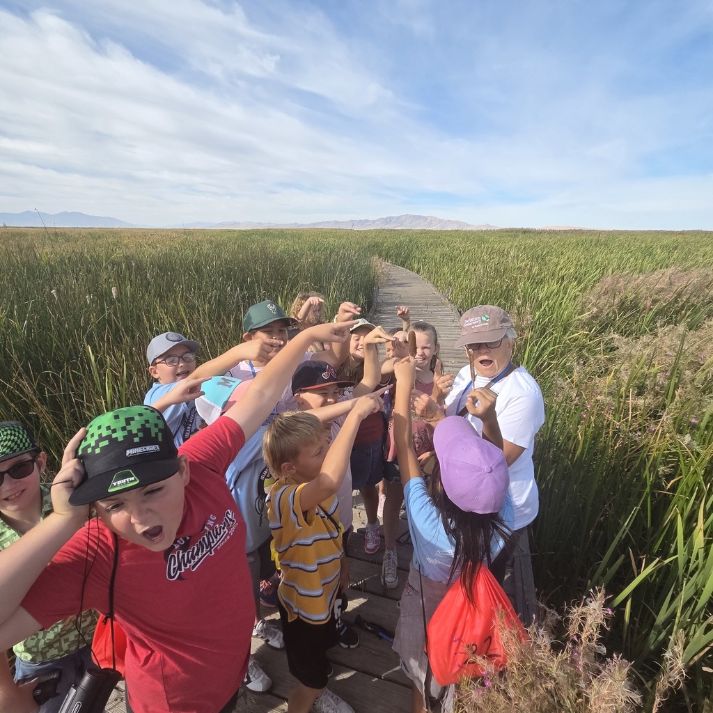 students showing a surprised face when pointing to something in the tour guides hands