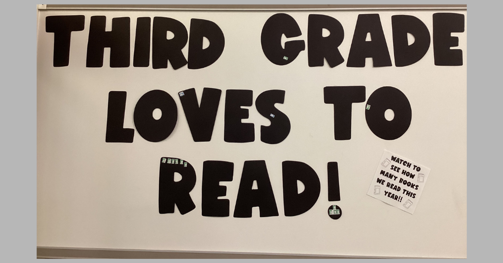 On a gray background is an image of a bulletin board with large black letters reading “THIRD GRADE LOVES TO READ!” A white paper in the corner says, “Watch to see how many books we read this year!!