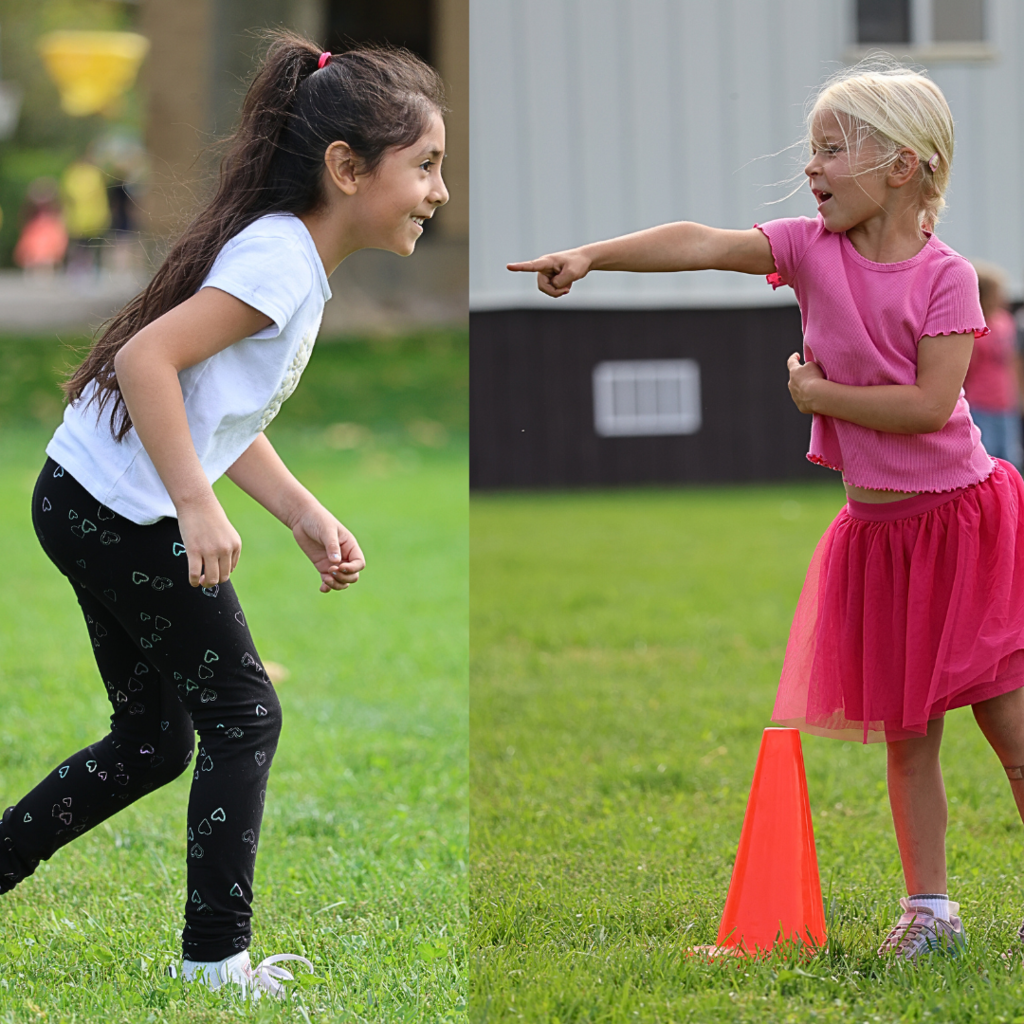 two students running. One is standing by a cone and pointing.