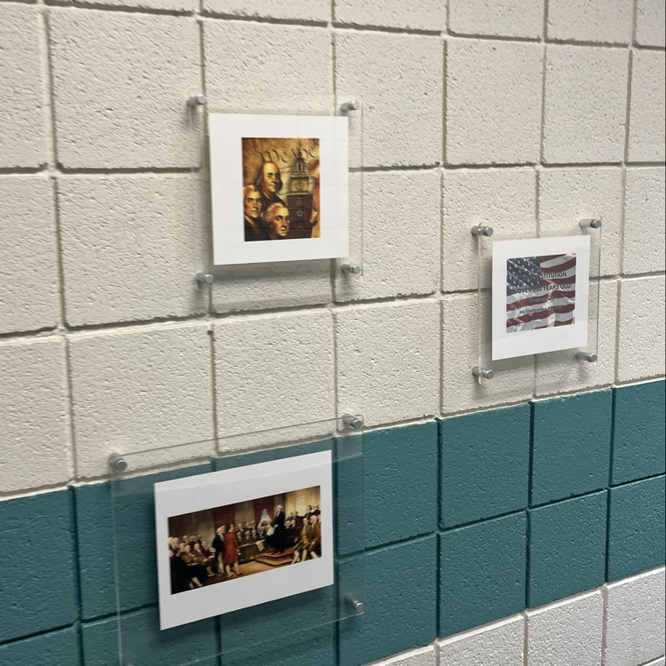 pictures line in the wall inside the school, depicting important events regarding the constitution.