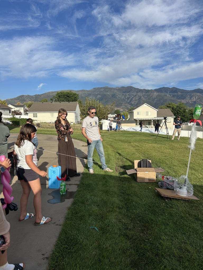 Sciene teachers help a girl with the rocket launch.