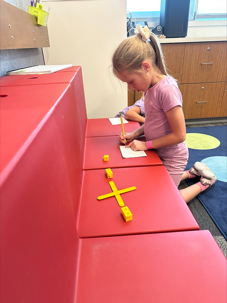 Student working individually with math cubes and popsicle sticks