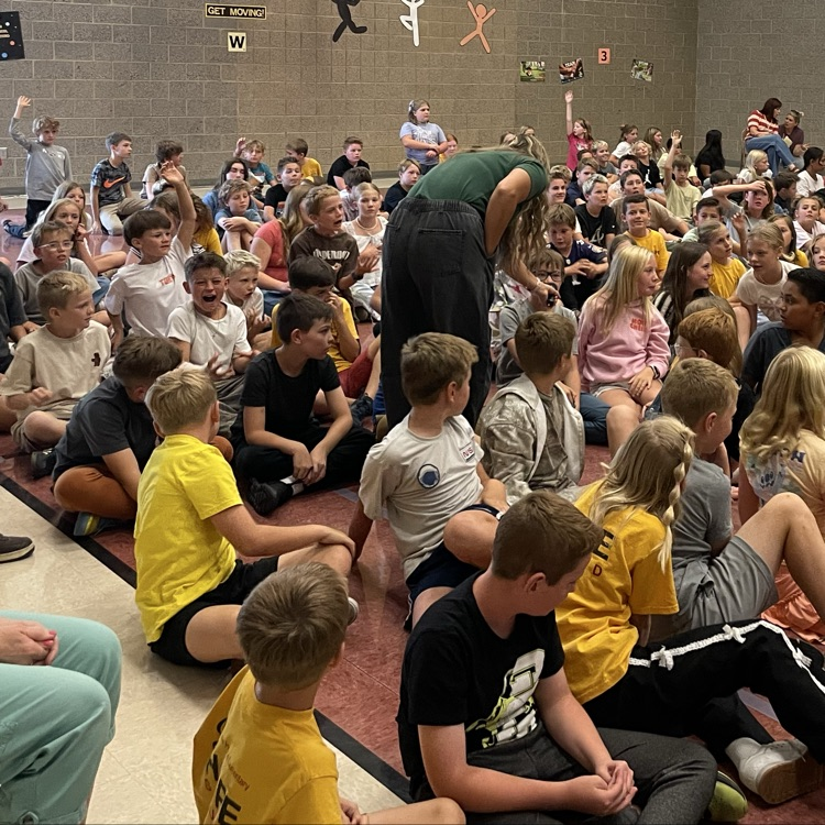 children sitting on the floor listening