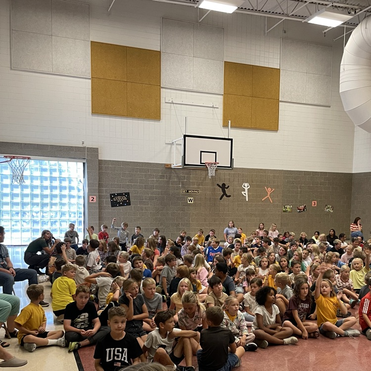 children sitting in the floor listening