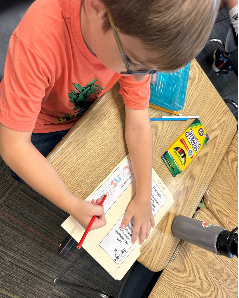 A student coloring in the word "Constitution"