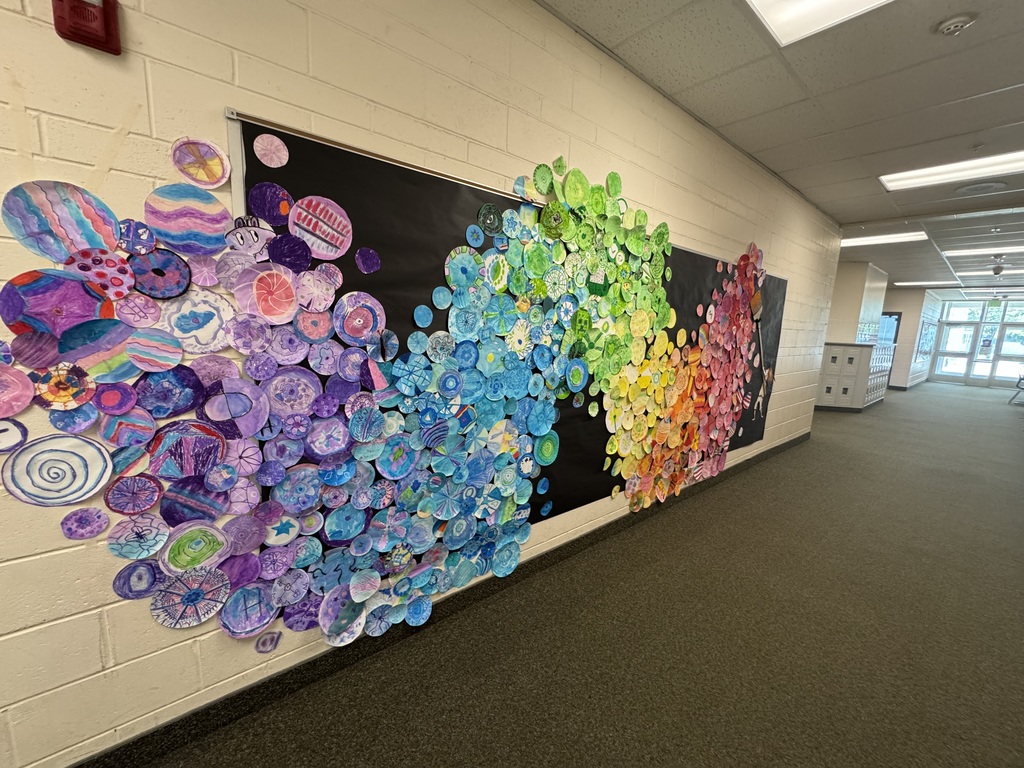 wall covered in student artwork based on the book The Dot