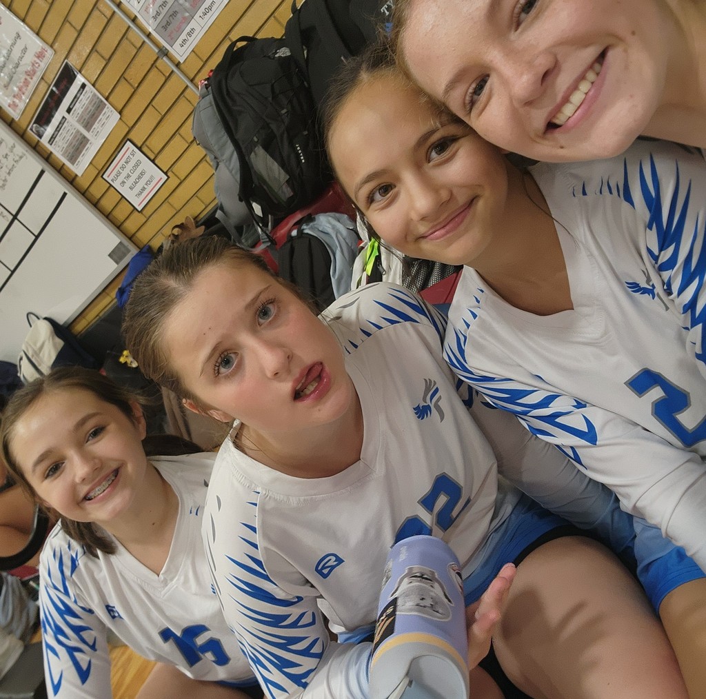 4 of Fairfield's JV girls sitting and smiling at the camera.