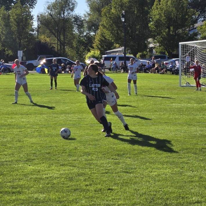 Layton soccer player keeping the ball away from an opposing player