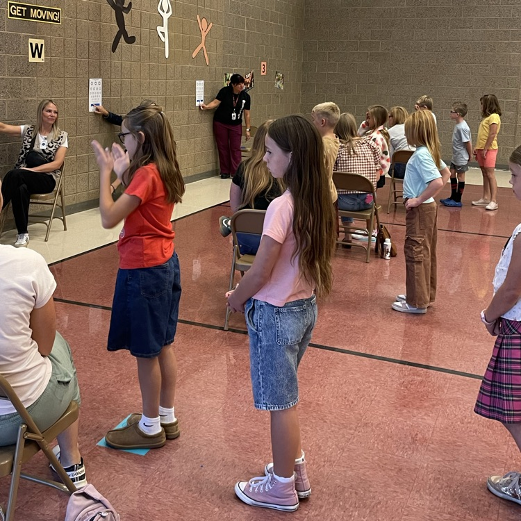 students in a line for an eye exam