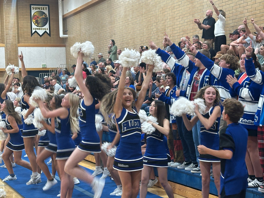 The Fairfield crowd is standing with one finger up for the last point in the game.  The Cheerleaders and crowd are erupting in cheers as Fairfield just won the game!