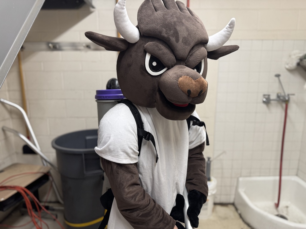 Chip the mascot with school vacuum on his back