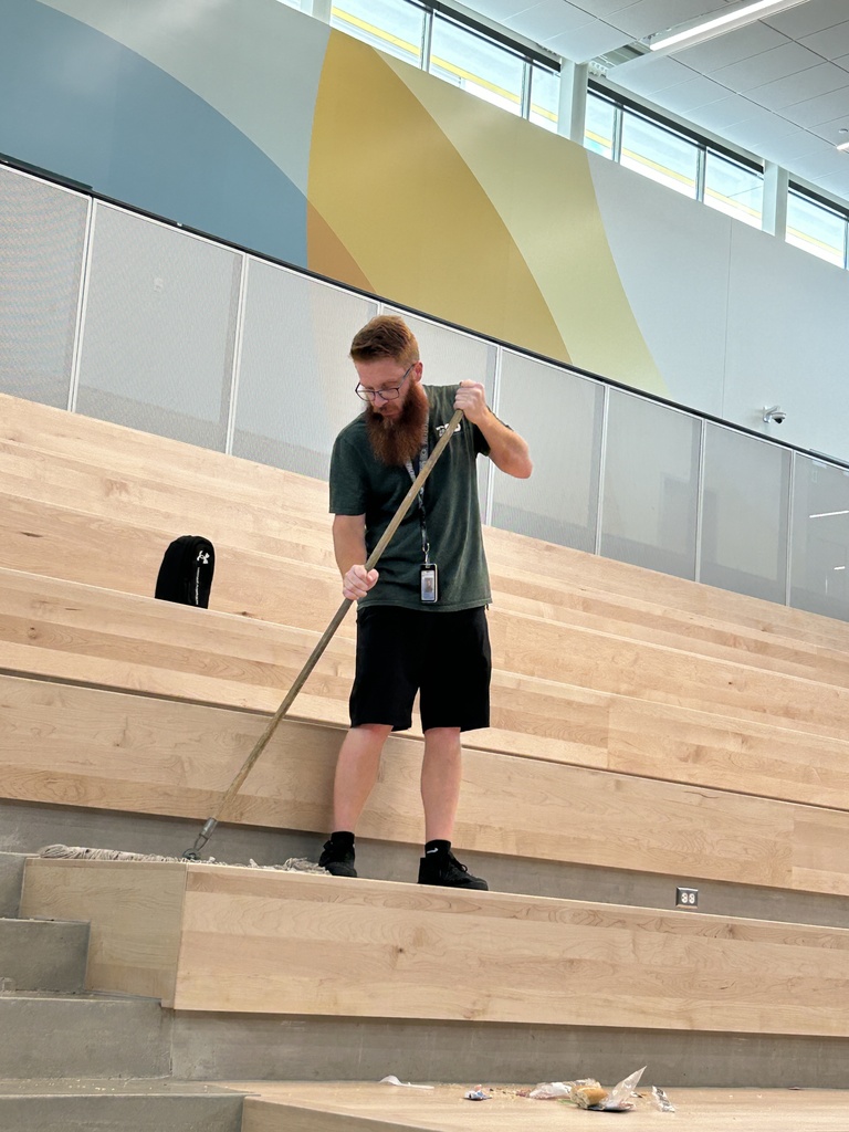 Mr. Cornford sweeping the stairs.