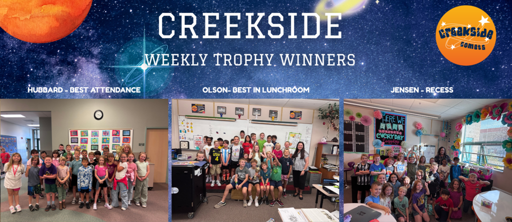 students holding a trophy in classrooms