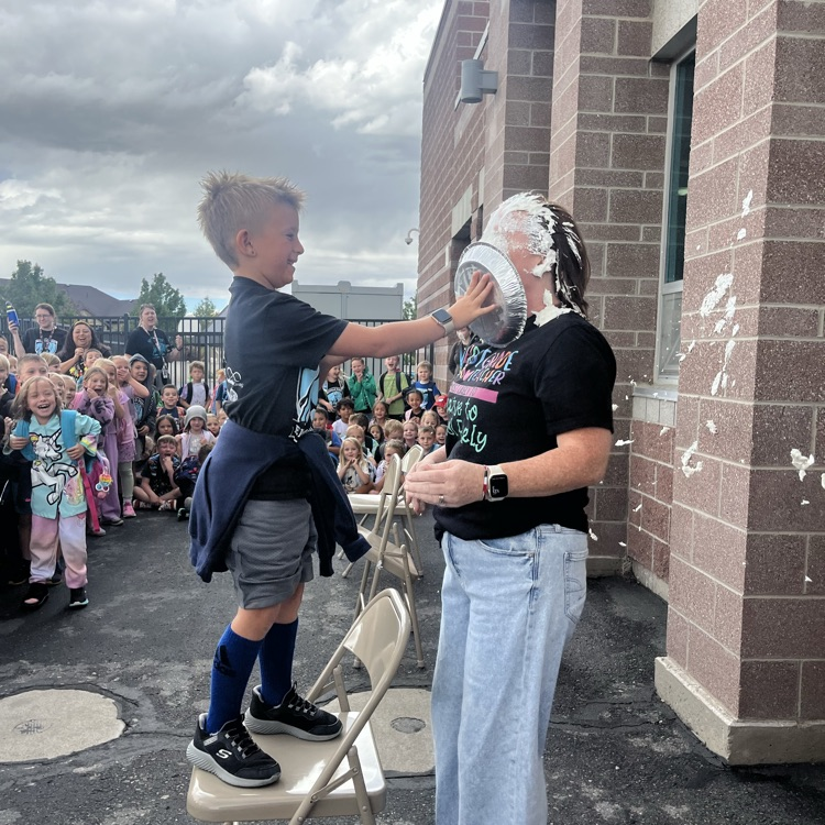 student putting pie in teacher’s face