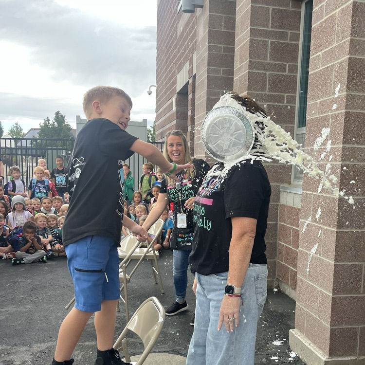 student putting pie in teacher’s face