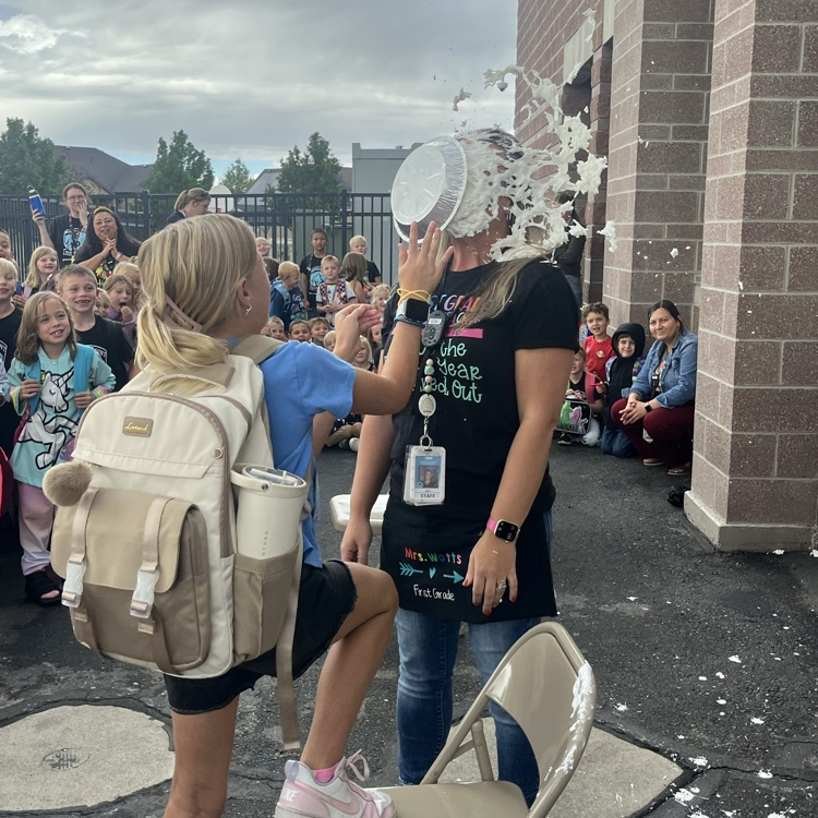student putting pie in teacher’s face