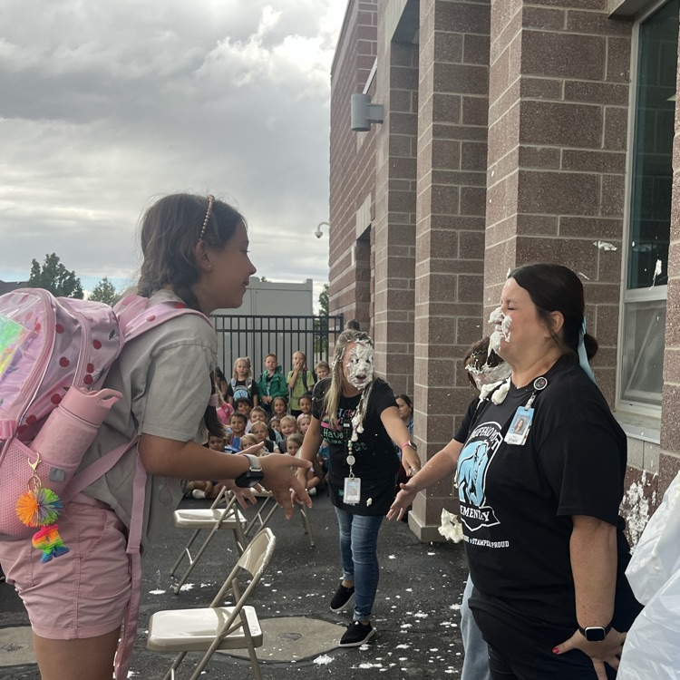 student putting pie in teacher’s face