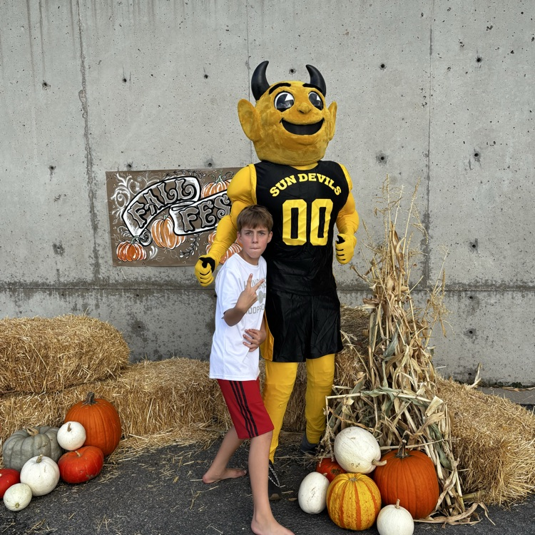 Sunset Junior High mascot Sunny the Sundevil with a young boy