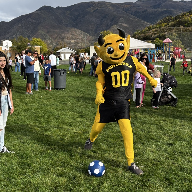 Sunset Junior High mascot Sunny the Sundevil kicks a soccer ball