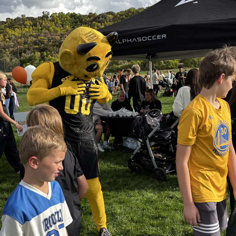 Sunset Junior High mascot Sunny the Sundevil talks to young students
