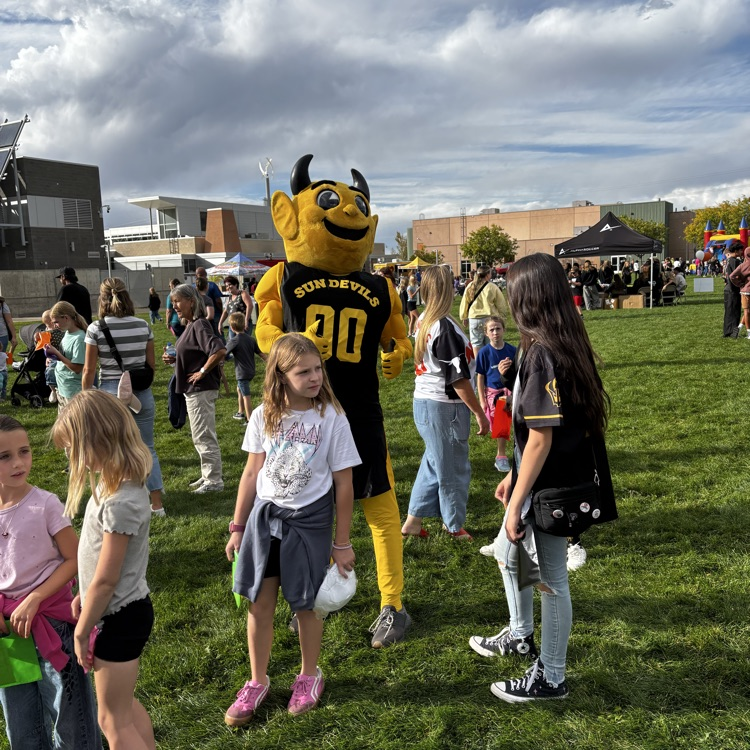 Sunset Junior High mascot Sunny the Sundevil poses with young children